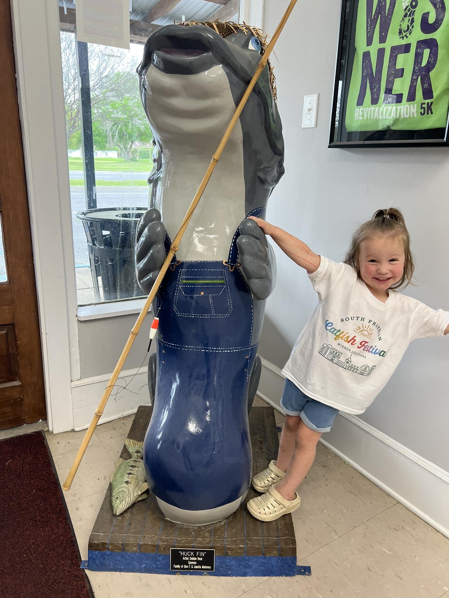 Young festival-goer with the catfish statue